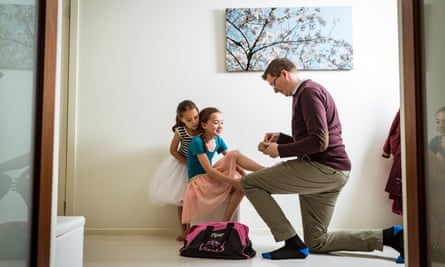 Mike Dwyer helps his eldest daughter Piper with her jazz shoes before a dance lesson