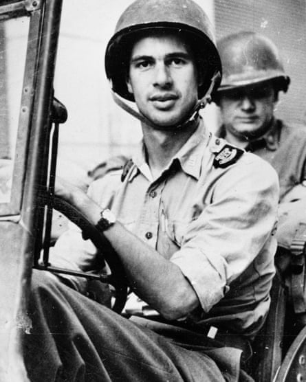 John Hersey driving a US army jeep in 1944.