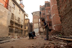Children play in area where damaged buildings were destroyed in Kathmandu, Nepal
