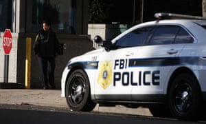 A security guard stands at the entrance of a garage at an FBI field office in Washington DC on Monday.