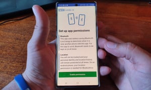 An Isle of Wight resident poses with his smartphone showing the NHS Covid-19 app
