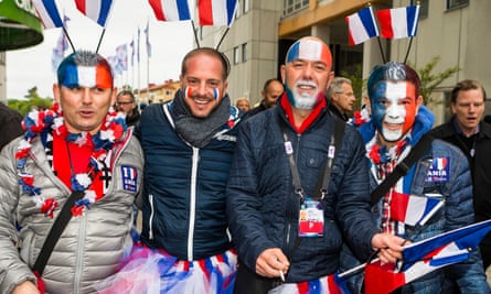 Four fans from France with foreheads or faces painted with the French flag