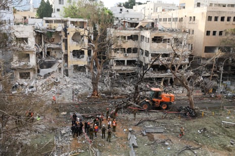 Emergency personnel work at an impact site after missiles were launched from Iran to Israel, in Tel Aviv, Israel, 16 June, 2025.