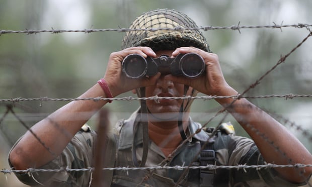 An Indian border security force soldier looks for potential threats, near Jammu in India.