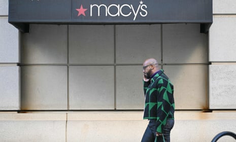 person walks past a Macy's storefront