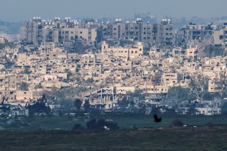 Damaged buildings stand amid rubble in central Gaza near the Israel-Gaza border, as seen from Israel.