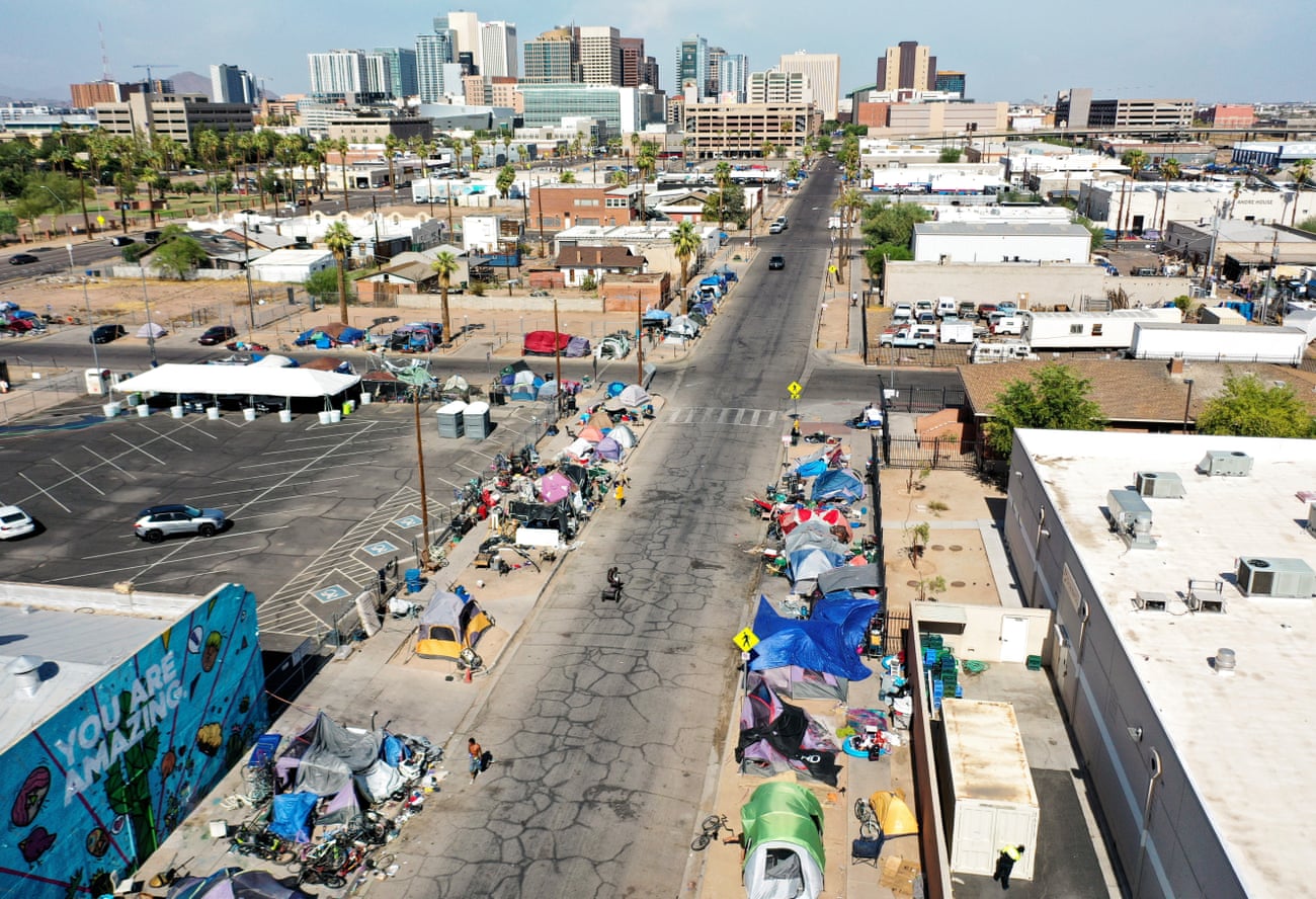 An aerial view of tents and makeshift shelters in the afternoon heat.