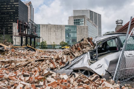A car is seen under rubble after a building was destroyed by Hurricane Ida in New Orleans.