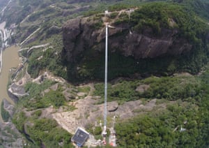 A shimmering white line cuts across a valley in Shiniuzhai national geological park. This vertigo-inducing, glass-bottomed suspension bridge has just opened to the public.