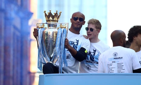 Vincent Kompany shows off the Premier League trophy during Manchester City’s parade on Monday