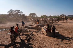 People stand next to a water well at the village of El Gel, 8km from the town of K’elafo, Ethiopia