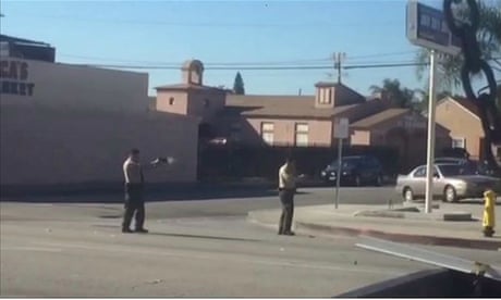 A screengrab from a video on the LA Times website that it says was filmed by a witness to a police shooting at Lynwood, California on 12 December 2015. In the video, many gunshots can be heard and a man who was walking away from police is later seen to be on the ground. http://www.latimes.com/local/lanow/la-me-ln-sheriff-s-deputies-fatally-shoot-man-in-lynwood-caught-on-videotape-20151212-story.html