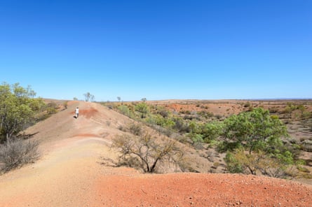 Tourist walking around Henbury craters, the site of a meteorite impact, Stuart Highway, Northern Territory.