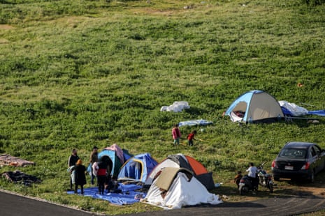 Displaced Lebanese people, who fled the country’s south, stand in front of their tents at Beirut water front.