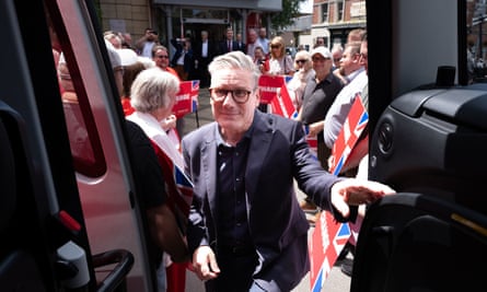 Keir Starmer boards Labour’s campaign battlebus as supporters carry party placards behind him