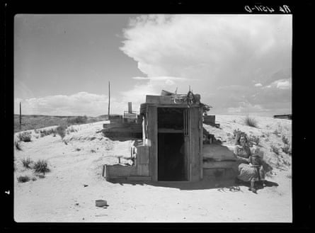 black and white photo of a door to a dugout in a desert landscape