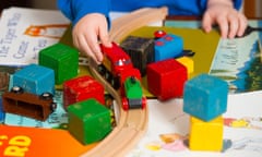 Child playing with train set
