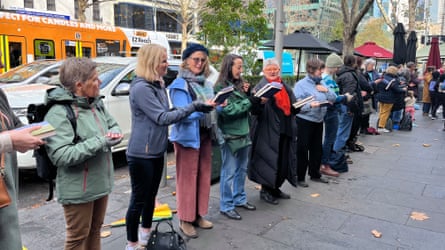 Line of people passing on books