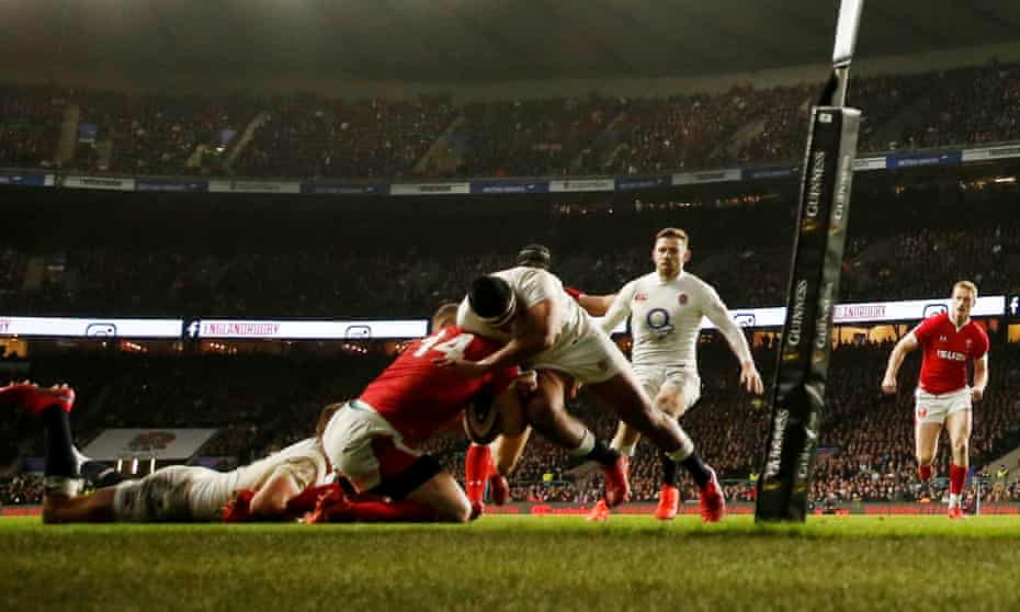 England’s Manu Tuilagi tackles Wales’ George North near the England try line. He was shown the red card for the tackle.