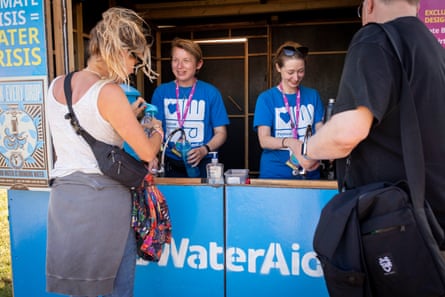 Volunteers on duty at a WaterAid point at Glastonbury festival.