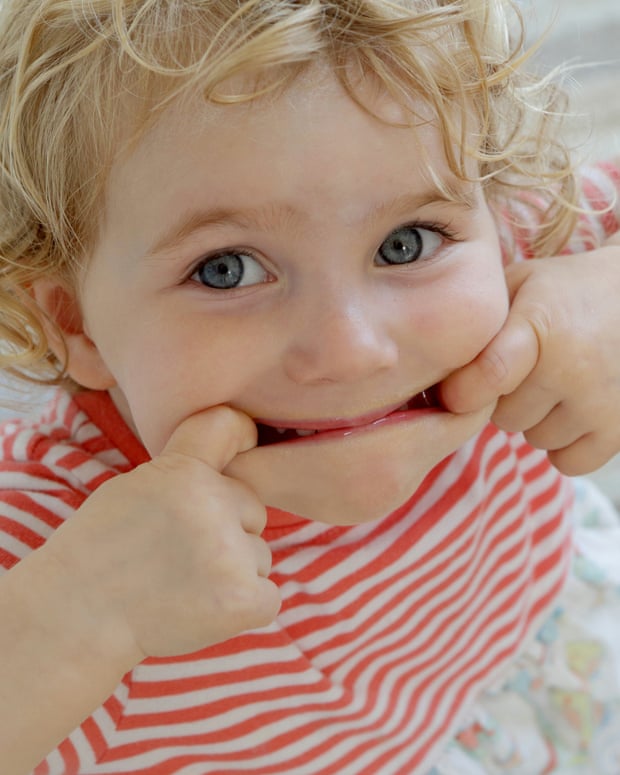 Toddler pulling the corners of his mouth out with his fingers