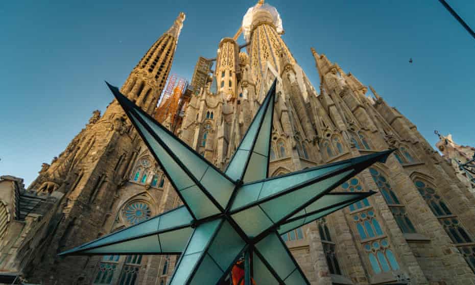 An operator works on a huge crystal star ahead of being installed atop the Virgin Mary's Spire of the  Sagrada Familia.