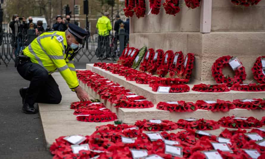 A police officer lays wreaths at The Cenotaph in central London
