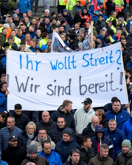 Volkswagen workers hold a banner reading "you want a strike? we are ready!" during a strike against planned cuts to wages and possible factory closures, in Hanover, Germany, today