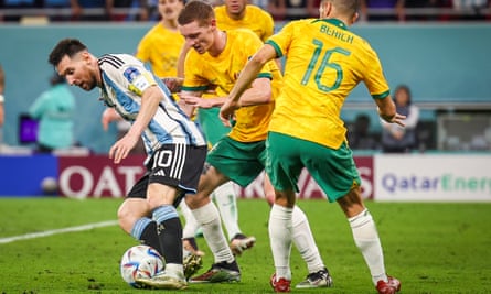 Lionel Messi shields the ball from a posse of Australia defenders.