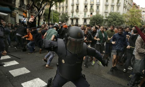 A Spanish riot police officer in Barcelona on Sunday