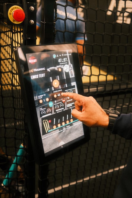 A user adjusts the settings on a tablet in the cricket nets