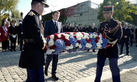Emmanuel Macron lays a wreath of flowers near the Pont de Bezons near Paris.