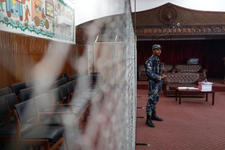 Police personnel stand on guard at a vote-counting station.