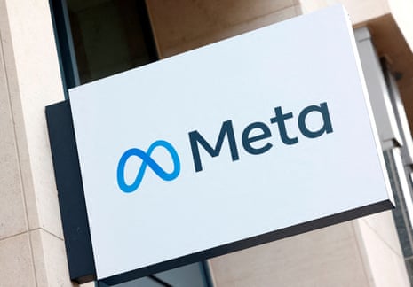 the logo for "Meta" on a sign outside a building