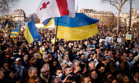 Thousands of people, some with Ukrainian flags, protest in Bastille Square in Paris