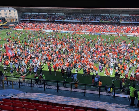Fans invade the pitch after Dundee United’s victory over Aberdeen at Tannadice Park..