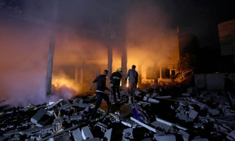 Firefighters tackle a blaze after an Israeli attack on the house of the al-Tavil family in Az-Zawayda, Gaza City.