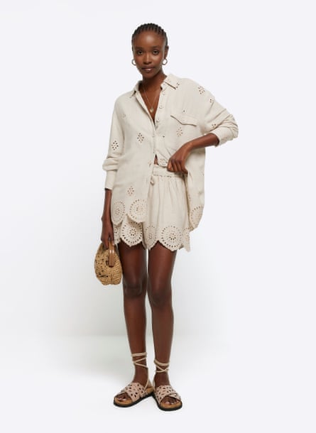 Model wearing cream broderie anglaise shirt and shorts