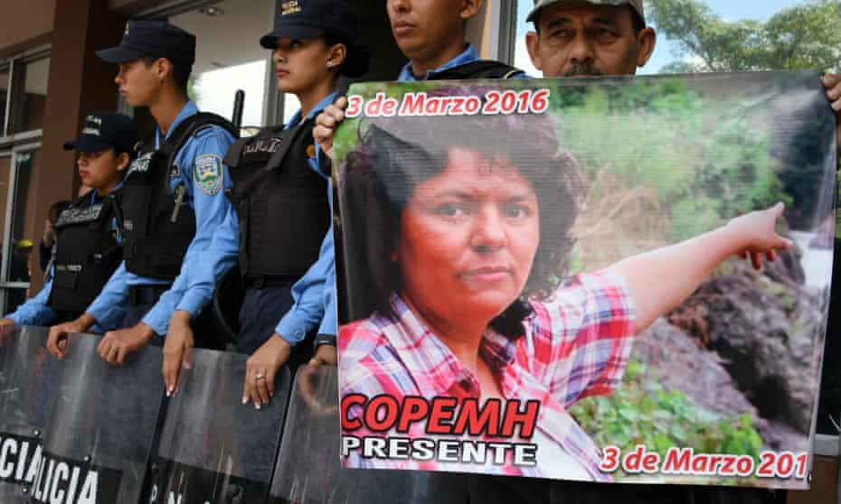 A man holds a poster during a protest in demand of justice over the murder of Honduran activist Berta Cáceres, during the second anniversary of her death, at the public ministry headquarters in Tegucigalpa on Friday.