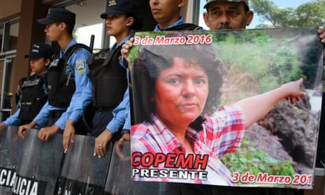 A man holds a poster during a protest in demand of justice over the murder of Honduran activist Berta Cáceres, during the second anniversary of her death, at the public ministry headquarters in Tegucigalpa on Friday.