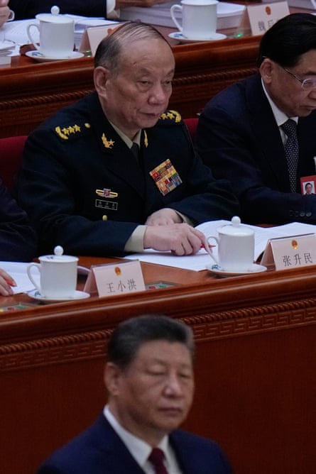 Zhang Shengming, top, sits behind Chinese leader Xi Jinping during the opening session of the fifth plenum in Beijing.