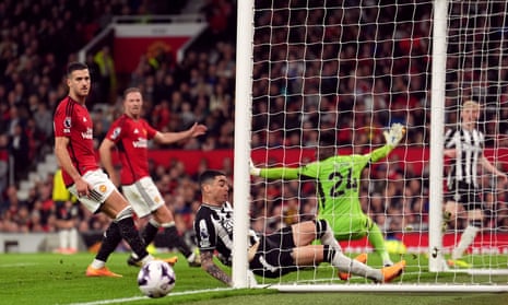 Newcastle United's Anthony Gordon shoots wide as Miguel Almiron slides in during the Premier League match at Manchester United.