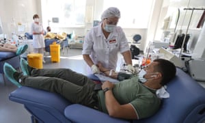The man donates blood at a blood transfusion station in St. Petersburg, Russia, where supplies are low.