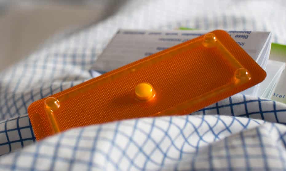 An abortion pill is seen on a bed