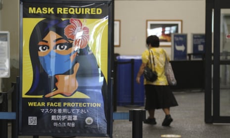 A sign at Hawaii’s international airport in Honolulu advises visitors of the state’s mask mandate.