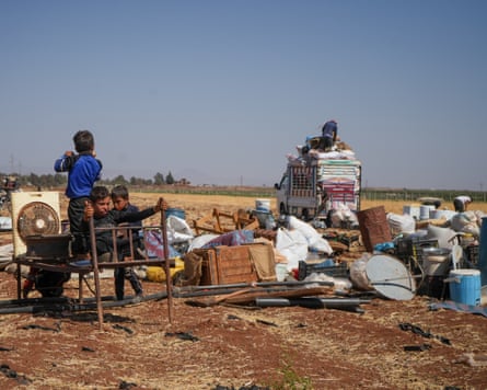 Arab Bedouins rest in the open with their belongings