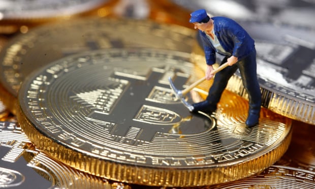 A small toy figure is seen on representations of the Bitcoin virtual currency.