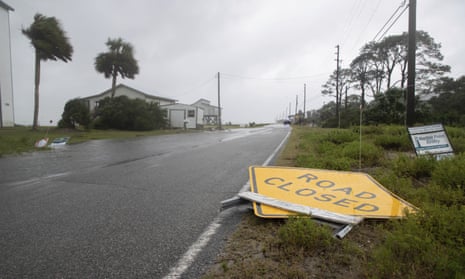 A road sign is blown over in Alligator Point, south of Tallahassee, as Tropical Storm Fred brings strong winds and rain to the Florida’s ‘forgotten coast’.