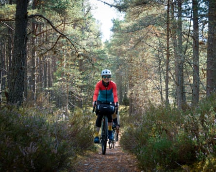Ailsa Sheldon riding a bike through a wooded area