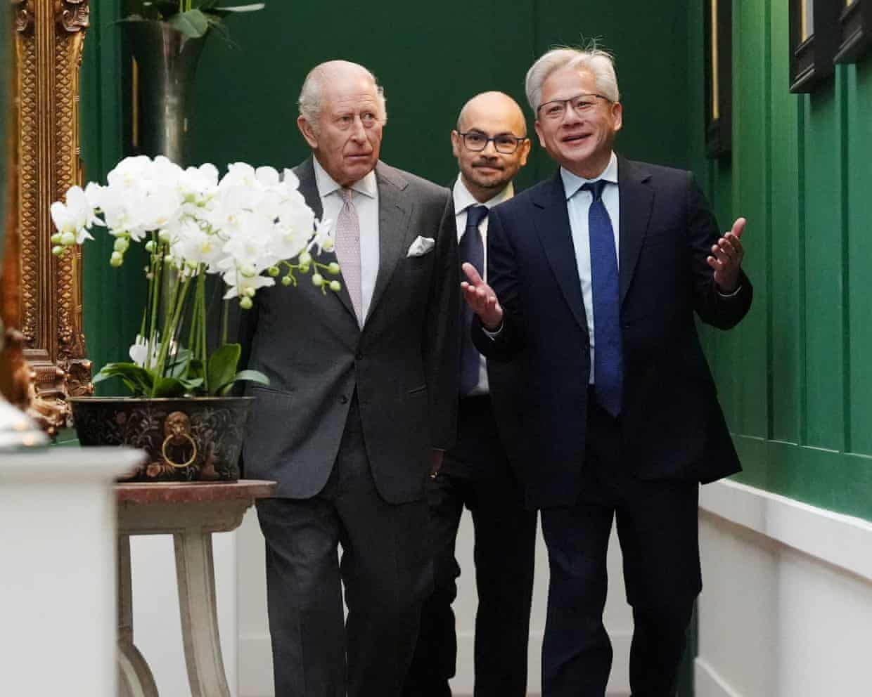King Charles walking down a corridor with the AI researcher Demis Hassabis and the Nvidia CEO, Jensen Huang, at Dumfries House in Cumnock, Scotland